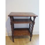 An oak three tier side table, probably Liberty & Co, with lattice work sides on short turned legs,