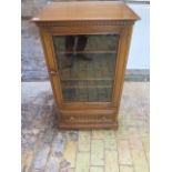 An Ercol elm glazed cabinet and base drawer, 97cm tall x 56cm x 49cm, some usage marks but generally