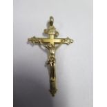 A continental yellow gold crucifix, approx 6cm x 3.5cm x 7.9cm, no hallmark but tests to above