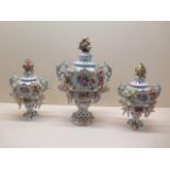 A Sitzendorf 3 piece garniture set floral encrusted with cherubs, centre vase 33cm tall and some