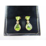 A pair of 9ct gold and peridot earrings, stamped 9K, 122mm drop, approx weight 2.2 grams, minor