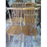 A set of four ercol 1960 elm seated kitchen chairs, numbers 2056, two have slight movement and one