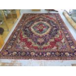 A hand knotted woollen Tabriz rug, 3.5m x 2.45m, colours bright in generally good condition