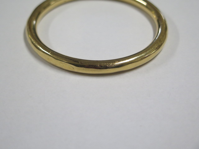 A yellow gold bangle tests to approx 18ct, approx 19.8 grams, 7.5cm external diameter, dented and - Image 3 of 3