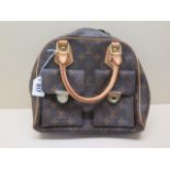 A Louis Vuitton monogrammed leather handbag with gilt metal hardware, 30cm wide, front left pocket