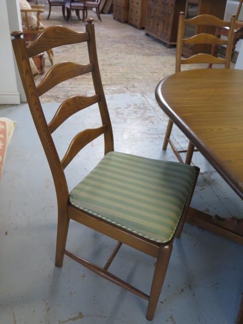 An Ercol elm oval extending dining table and 4 chairs with seat pads, 74cm tall x 166cm x 114cm - Image 3 of 7