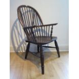 An ash and elm stick back Windsor chair, stamped 1938 to the underside, 106cm high, general age