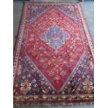 A hand knotted woollen Qashqai rug, 2.75m x 1.75m, in good condition with a slight colour variation
