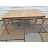 A teak garden table, 150cm long x 90cm wide