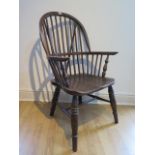 An ash and elm stick back Windsor chair, stamped 1938 to the underside, 106cm high, general age