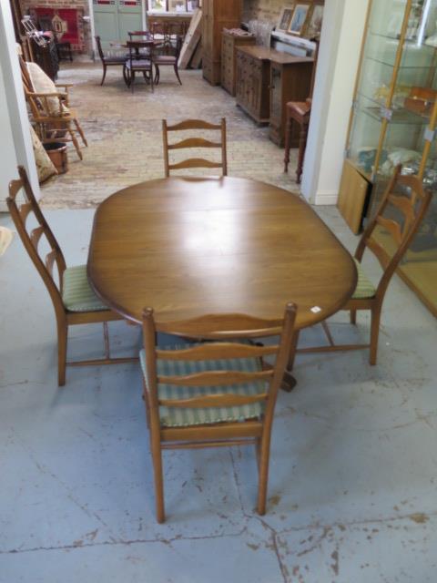 An Ercol elm oval extending dining table and 4 chairs with seat pads, 74cm tall x 166cm x 114cm