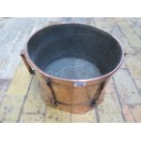 An Arts and Craft copper twin handled log bin, 25cm tall x 42cm wide