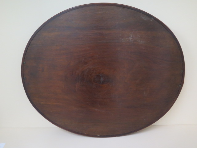 An early 1900s mahogany oval twin handle tray with a shaped rim, 71cm x 58cm - Image 2 of 4