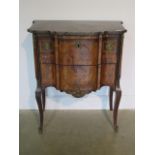 A French 19th century two drawer chest with marble top over a shaped marquetry inlaid base comprised