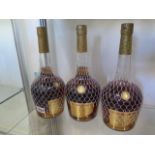 Three bottles of Courvoisier le Voyage de Napoleon VS Cognac retailing at £40 a bottle, level low on
