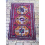 A new hand knotted woollen Baluchi rug, 1.35m x 0.85m