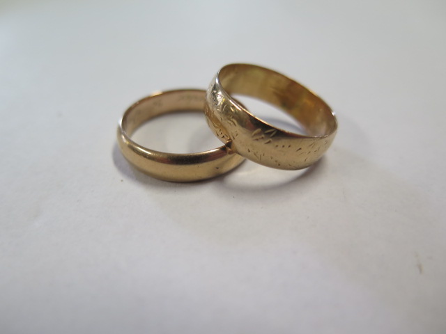 Two yellow gold band rings unhallmarked but test to approx 18ct, sizes T and Q, on has internal - Image 2 of 3