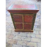 A small continental decorative painted two door cupboard, 67cm tall x 54cm x 31cm