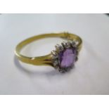An impressive continental gold Amethyst and diamond hinged bangle, the central Amethyst is approx