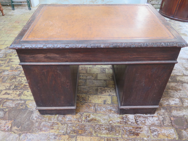 An oak kneehole writing desk with tooled leather top and ornate 'Green Man' carved drawers, 107cm - Image 3 of 6