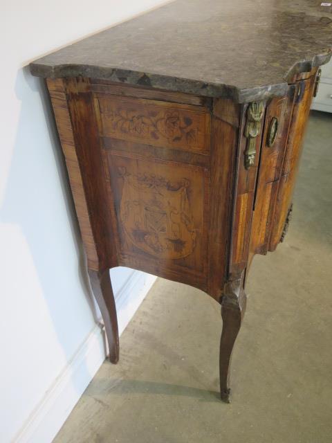 A French 19th century two drawer chest with marble top over a shaped marquetry inlaid base comprised - Image 5 of 10