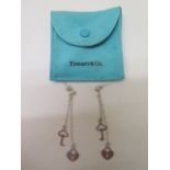 A pair of Tiffany and Co .925 sterling silver lock and key earrings, stamped .925, with a suede