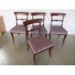 A set of four Regency mahogany bar back dining chairs with upholstered seats and fluted sabre
