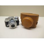 A miniature Japanese shutter camera in case, 5cm wide, working
