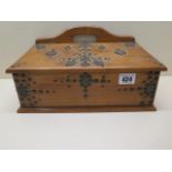 An early 20th century Continental wooden desk top box with applied metal work decoration and