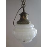 A brass and opaque glass ceiling light of moulded fluted form suspended on a linked chain, 38cm