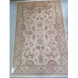 A handwoven Persian Ziegler rug with cream ground and wide foliate border, 1.8m x 1.2m, minor wear