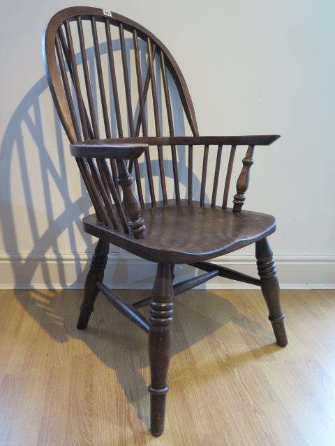 An ash and elm stick back Windsor chair, stamped 1937 to the underside, 106cm high, general age