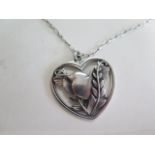 A silver pendant on chain by Georg Jensen, designed by Arno Malinowski, of a robin in fern fronds