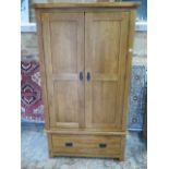 An oak two door wardrobe with a single base drawer, comes in 2 parts, 193cm tall x 109cm x 58cm,