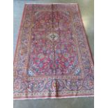 A hand knotted woollen Kashan rug, 2.10m x 1.38m, some colour variation