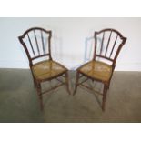 A pair of Victorian beechwood side chairs with canned seats, some wear but generally good
