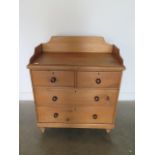 A Victorian stripped pine four drawer chest with galleried top in polished condition, 106cm tall x