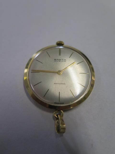 An 18ct yellow gold Barth of Zurich antichoc lapel watch, manual wind, 34mm wide, hands advance