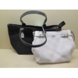 A Kate Spade white leather shoulder bag with gilt metal hardware, 35cm wide, and one further black