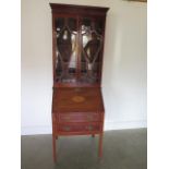 An Edwardian inlaid mahogany two drawer bureau bookcase with a fitted interior standing on square