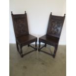 A pair of oak hall chairs with carved backs and frieze, 107cm tall x 52cm wide