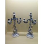 A pair of early 20th century four branch continental porcelain figural candelabra, blue painted