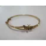 A continental yellow gold hinged bangle with sapphire and pearl set butterfly, external 6cm x 5cm,