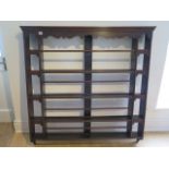 A 19th century oak plate rack of four shelves with carved cornice, 121cm wide x 120cm high x 14cm