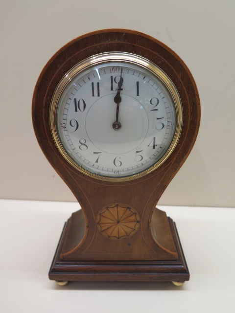An 8 day mahogany case balloon mantle clock with inlay, 23cm tall, running in saleroom