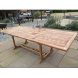 A teak extending garden table with two leaves measuring 3m x 1.10m, new ex-display