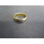 An 18ct yellow gold hallmarked band ring, size R, approx 3.8 grams