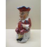 A Victorian style porcelain Toby jug modelled as Mr Punch wearing a striped suit and matching red
