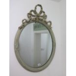 A painted ribbon top mirror with gilt highlights, 82cm x 58cm