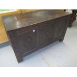 An 18th century oak three panel coffer with hinged lid and carved front, 123cm wide x 52cm deep x